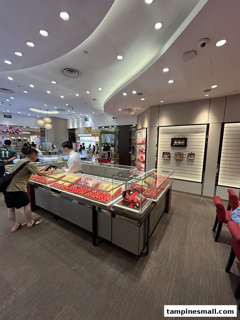 Interior view of SK Jewellery with customers browsing brightly lit gold and gemstone display cases.