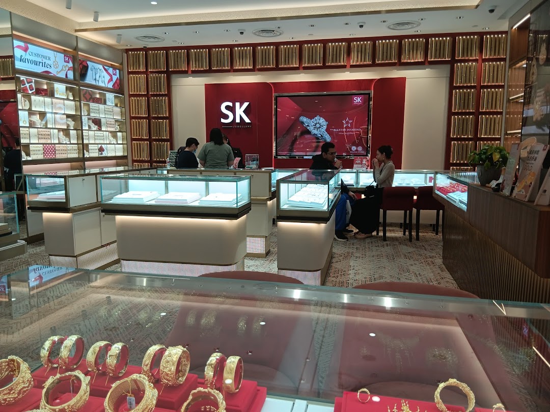 Interior view of SK Jewellery showcasing gold and diamond displays with customers browsing.