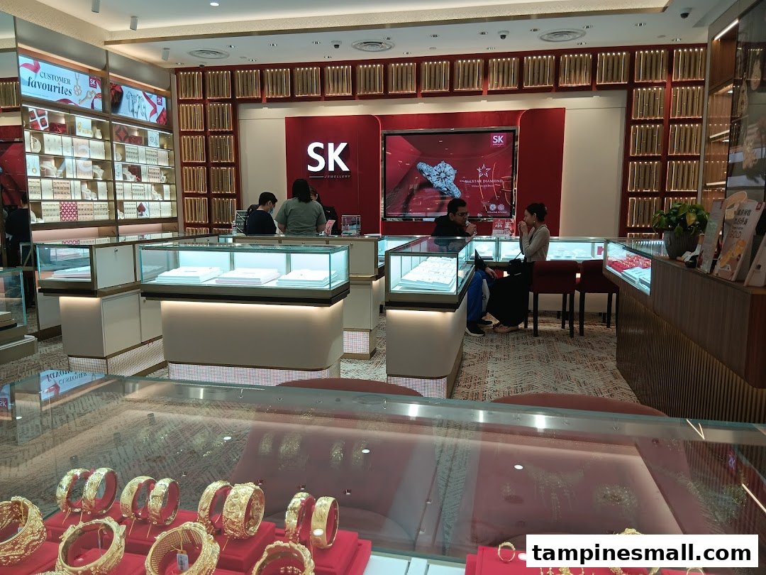 Interior view of SK Jewellery showcasing gold and diamond displays with customers browsing.