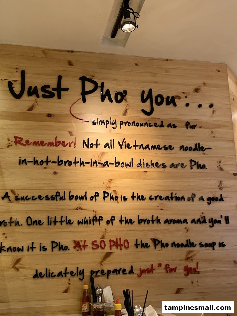 A wooden wall inside So Pho featuring text that explains the authenticity and essence of their Pho.