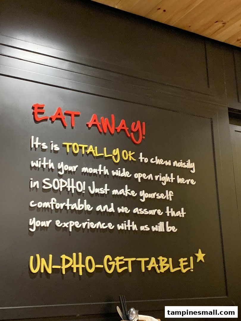 A playful wall sign inside So Pho encouraging a comfortable and 'un-pho-gettable' dining experience.