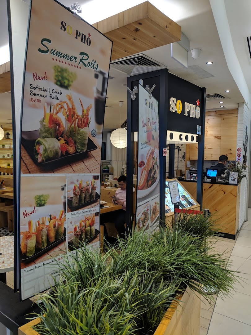 Promotional banners at So Pho's entrance showcasing various summer rolls with prices.