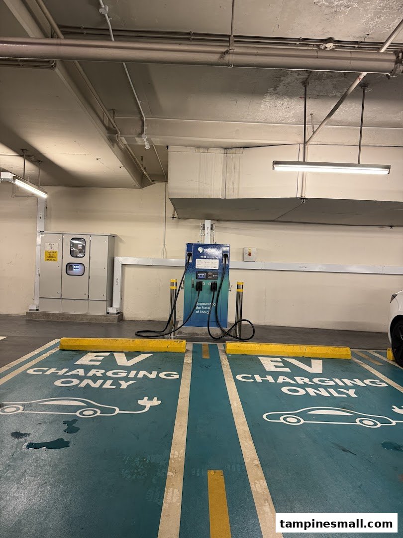 An SP Mobility EV charging station with two dedicated parking bays in an underground parking facility.