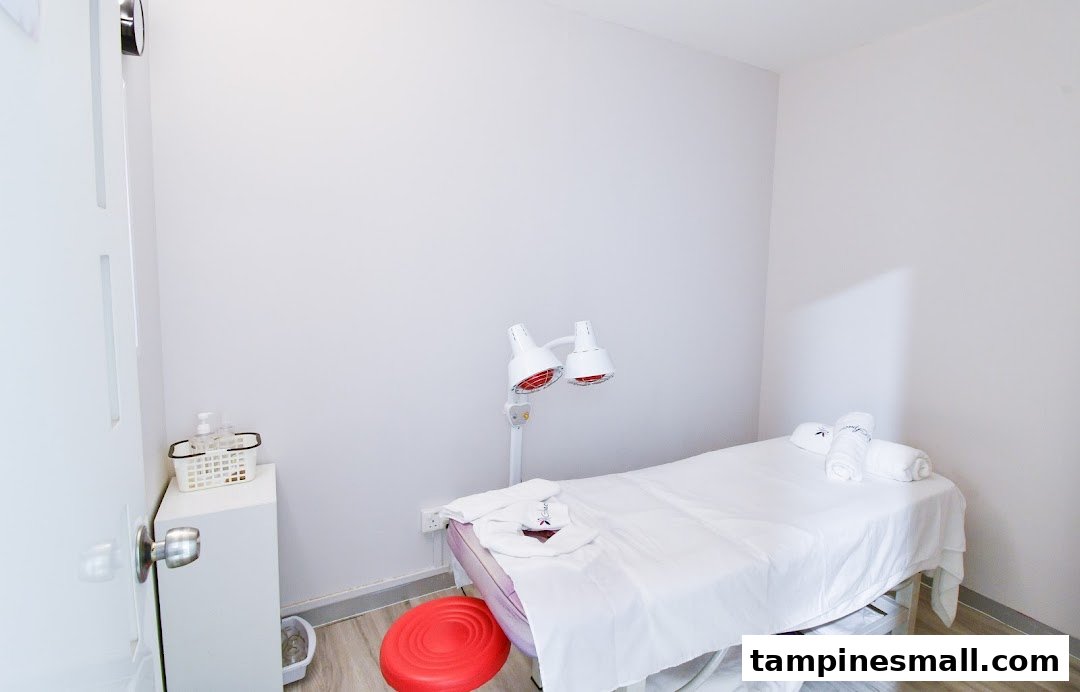 A clean, bright treatment room with a bed and infrared lamps at Spacio TCM Wellness.