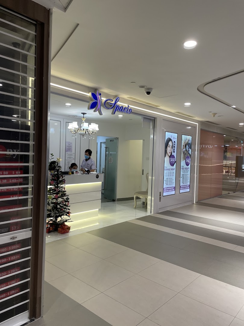The bright and inviting entrance of Spacio TCM Wellness, featuring a reception area and promotional displays.