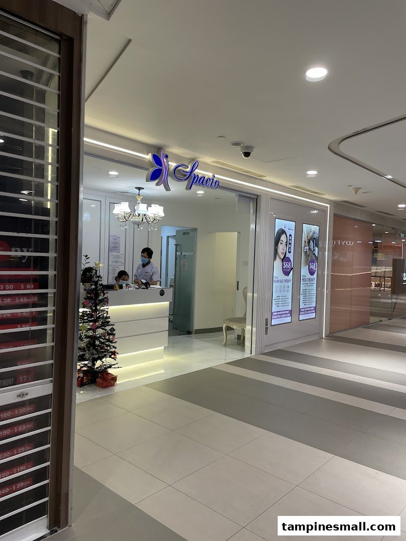 The bright and inviting entrance of Spacio TCM Wellness, featuring a reception area and promotional displays.