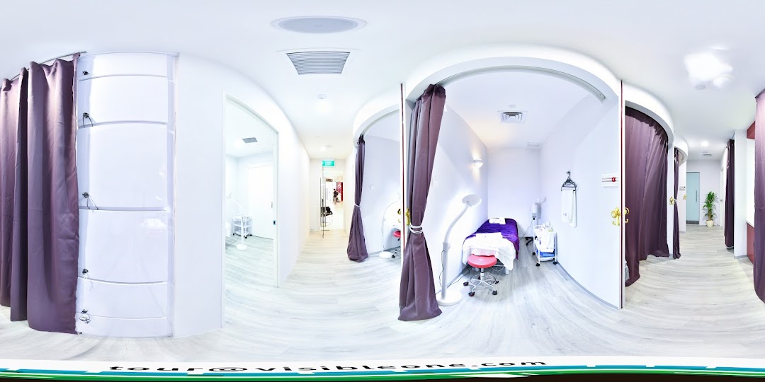 Interior view of a wellness center featuring private treatment rooms with curtains and modern decor.
