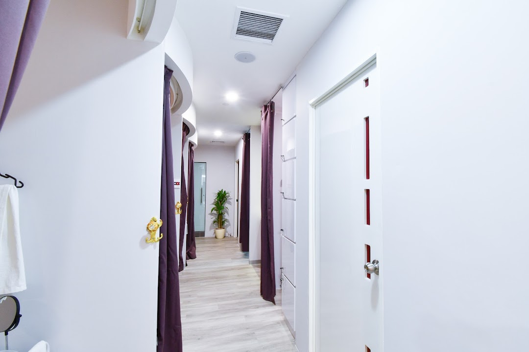 A clean, well-lit hallway with private treatment rooms at Spacio TCM Wellness.
