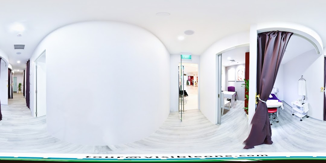 A clean, modern interior hallway of Spacio TCM Wellness with treatment rooms and an exit.