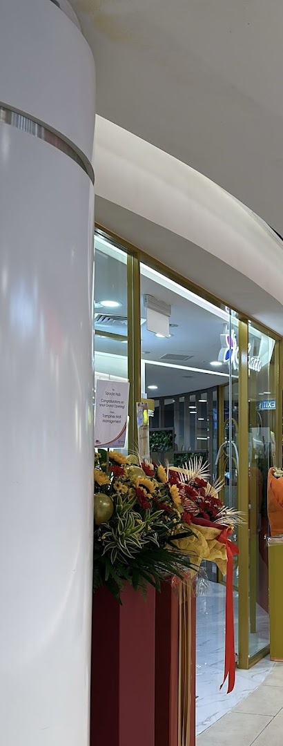 The grand opening of Spacio TCM Wellness Tampines, featuring a vibrant floral arrangement at the shop entrance.