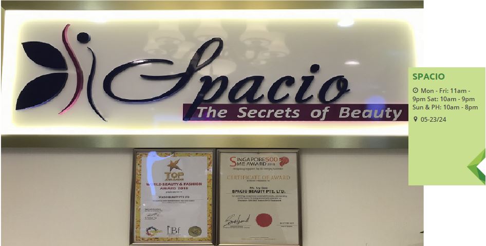 Spacio's illuminated sign displaying 'The Secrets of Beauty' alongside prestigious awards and operating hours.
