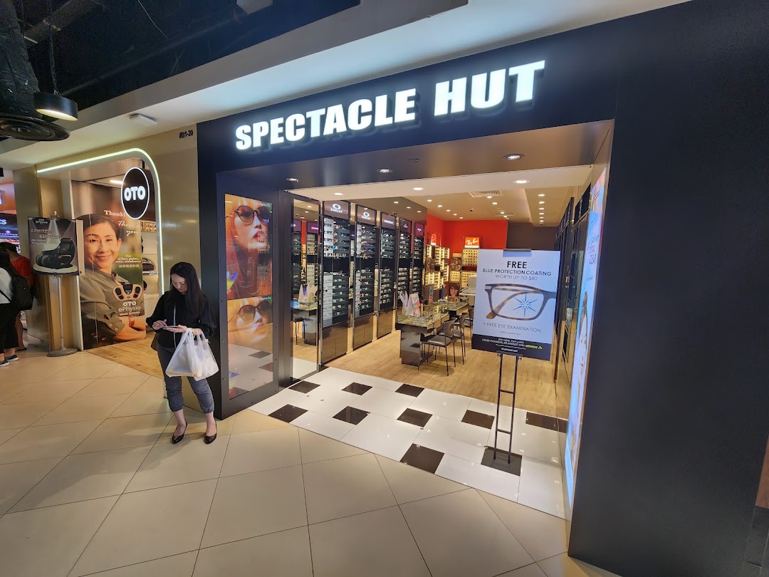 The shop front of Spectacle Hut, an optical store, featuring eyewear displays and promotional signage.