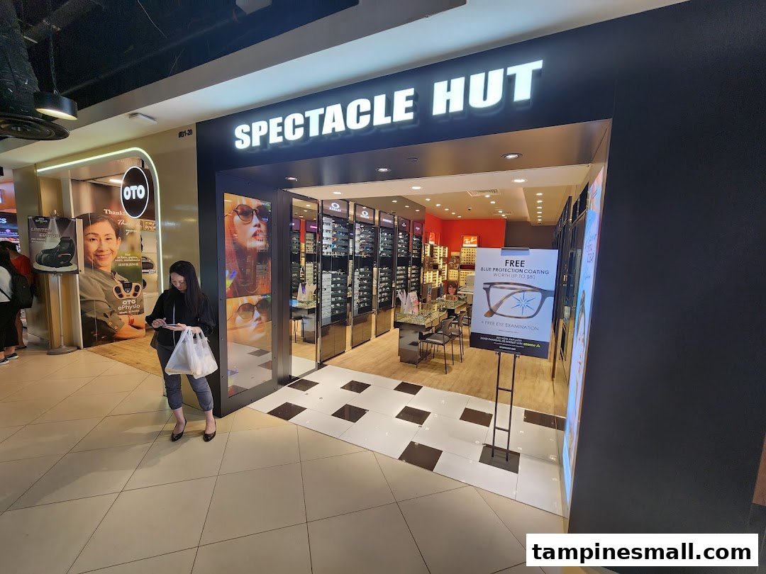 The shop front of Spectacle Hut, an optical store, featuring eyewear displays and promotional signage.