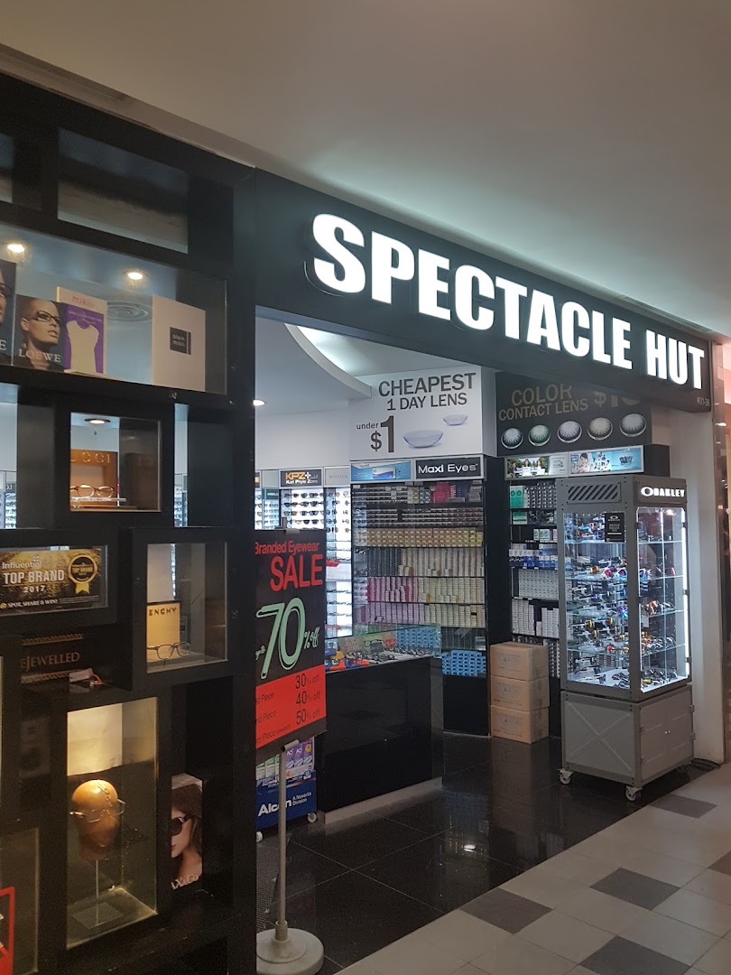 The brightly lit storefront of Spectacle Hut, showcasing eyewear and contact lens promotions.