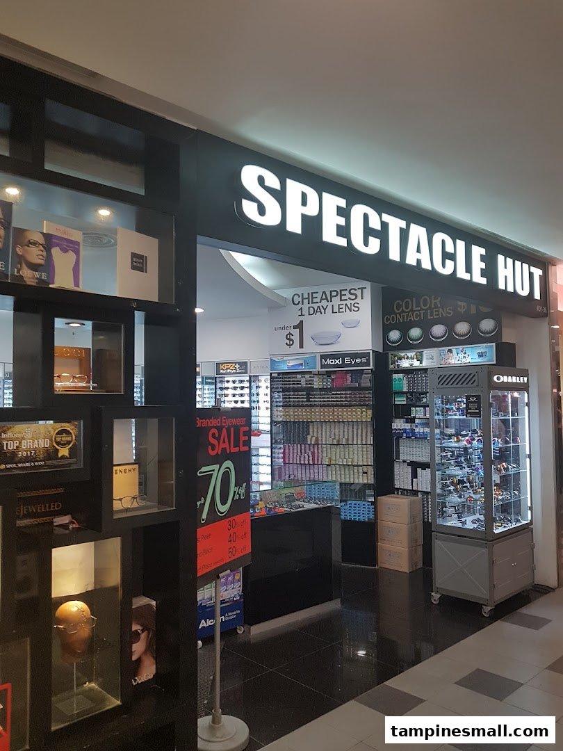 The brightly lit storefront of Spectacle Hut, showcasing eyewear and contact lens promotions.