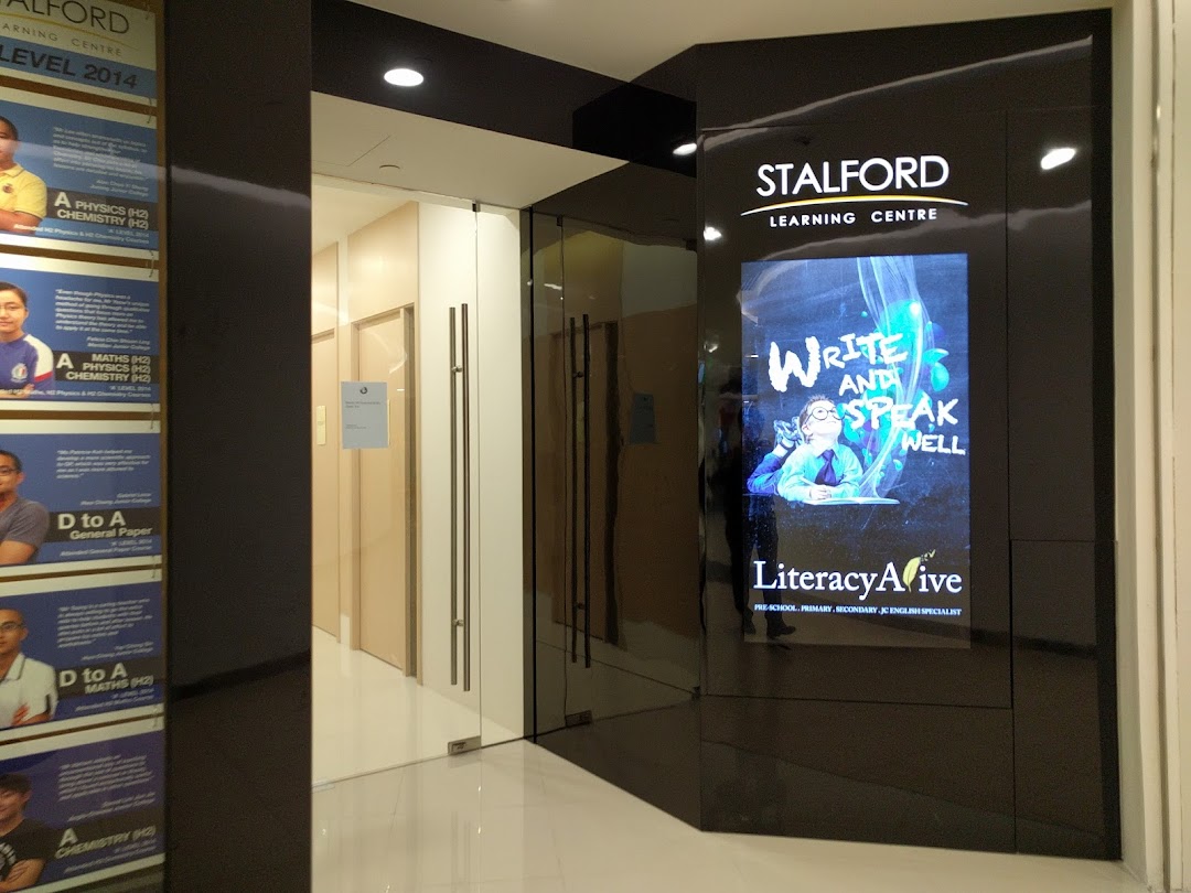 The entrance of Stalford Learning Centre at Tampines Mall, featuring a digital display and student testimonials.