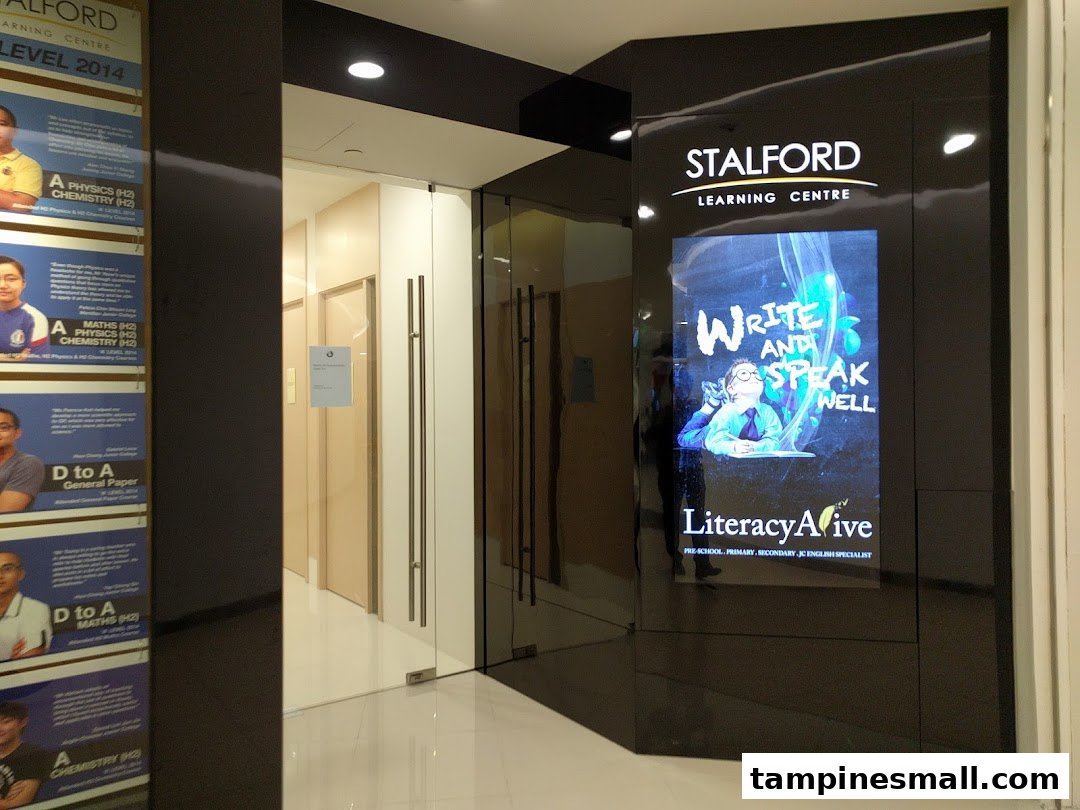 The entrance of Stalford Learning Centre at Tampines Mall, featuring a digital display and student testimonials.