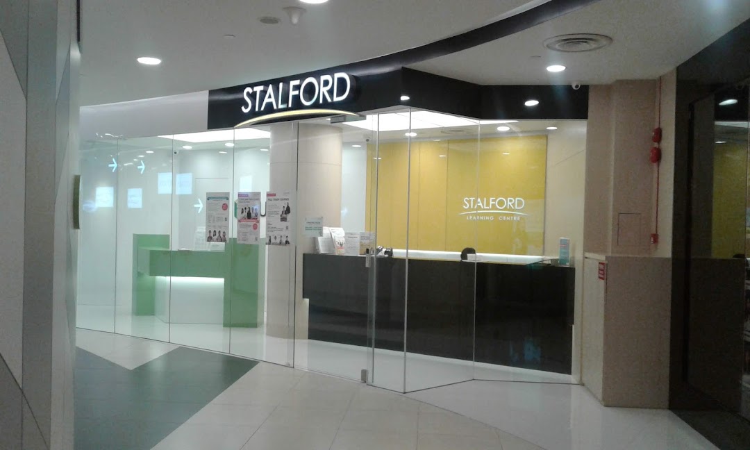 The modern glass entrance of Stalford Learning Centre, featuring reception desks and bright interiors.