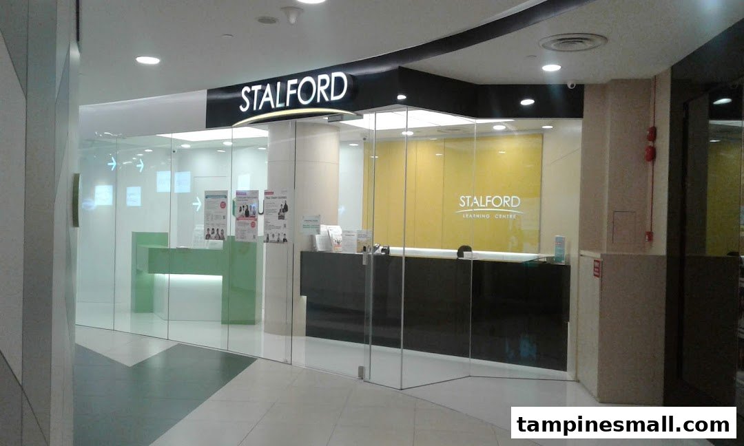 The modern glass entrance of Stalford Learning Centre, featuring reception desks and bright interiors.