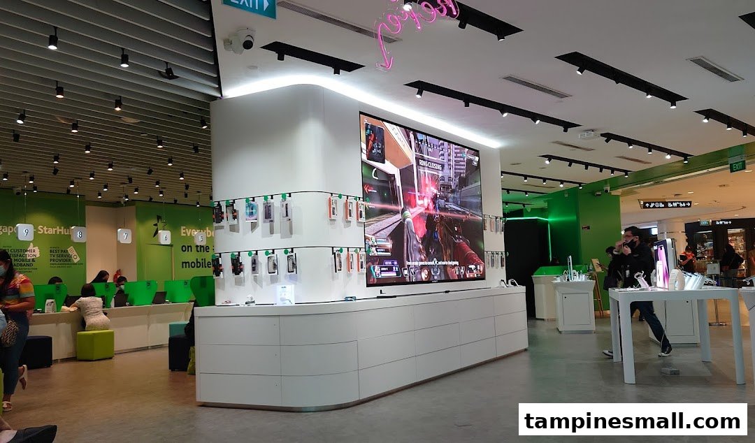 Interior view of StarHub store featuring a large display screen, mobile accessories, and customer service counters.