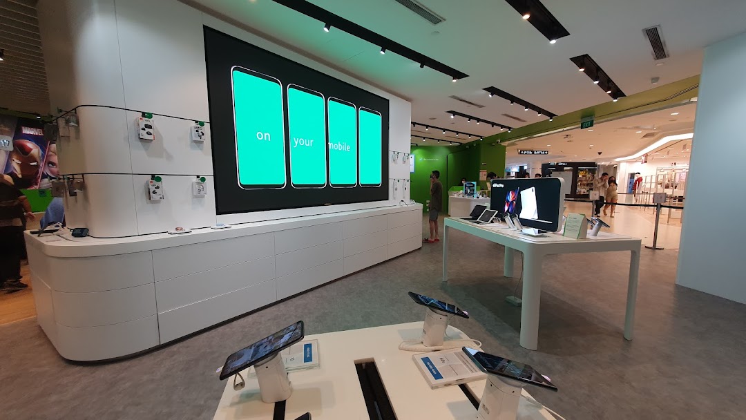 Interior view of StarHub store showcasing mobile devices, tablets, and a large digital display.
