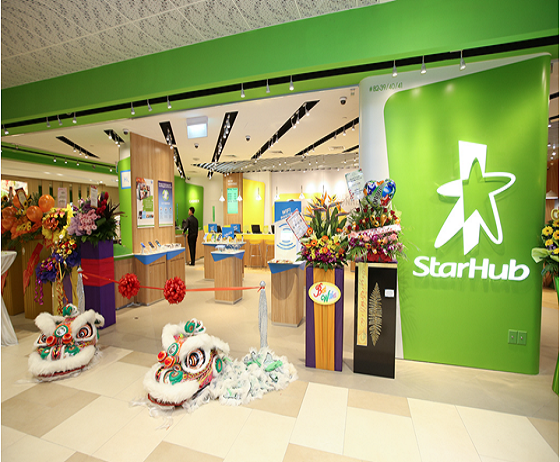 Vibrant StarHub shop entrance with festive lion dance decorations and welcoming floral arrangements.