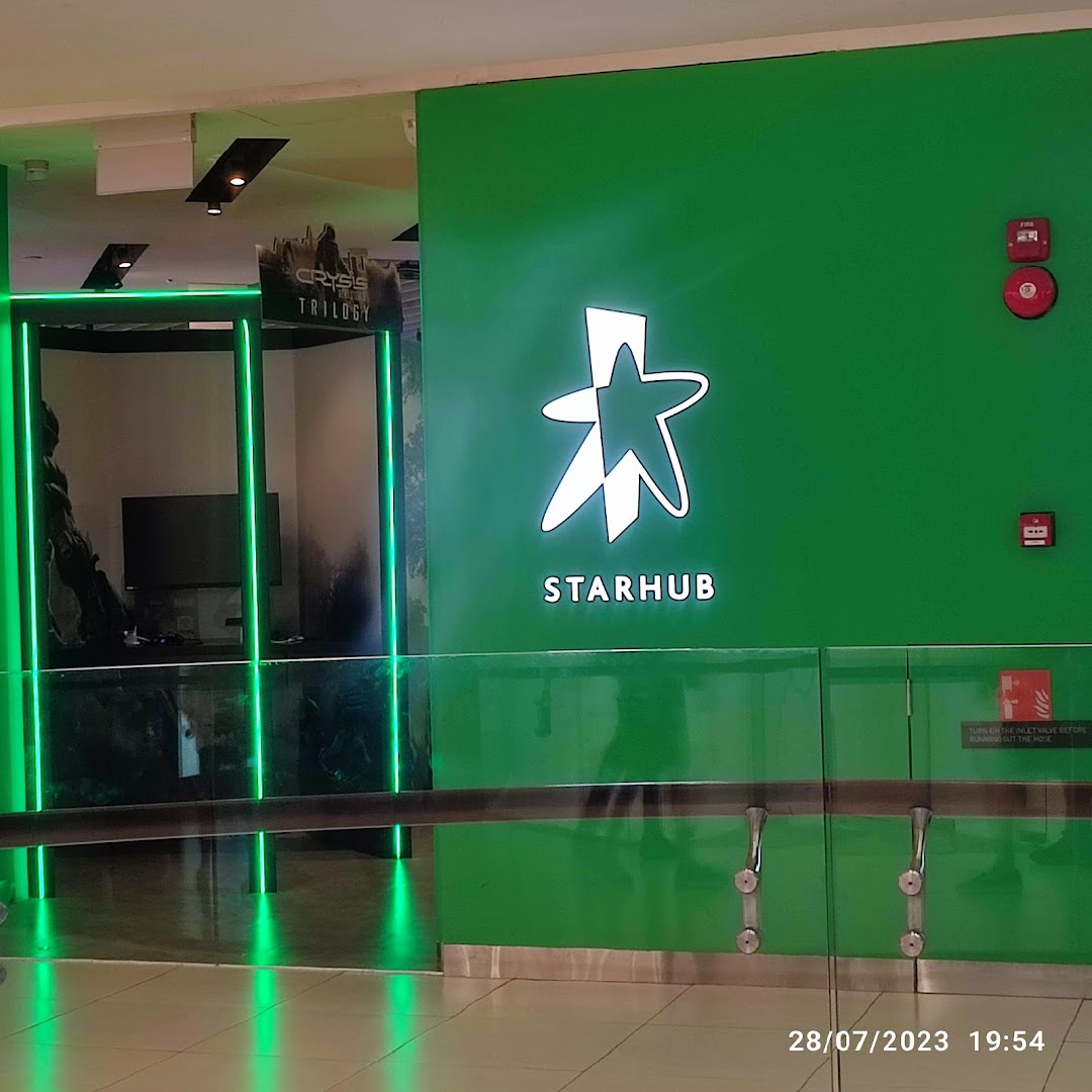 The vibrant green facade and entrance of the StarHub store, featuring its illuminated logo.
