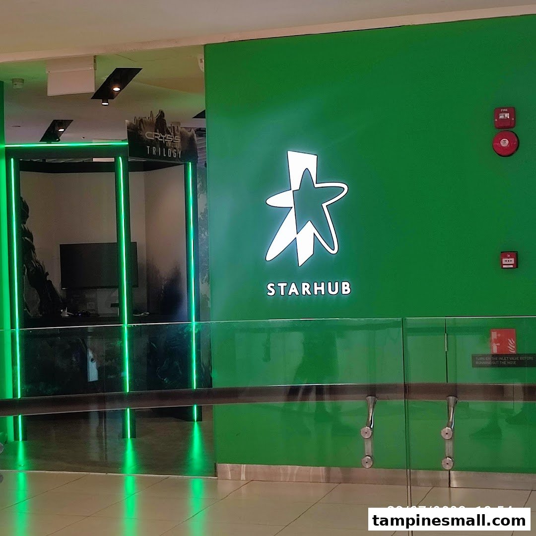 The vibrant green facade and entrance of the StarHub store, featuring its illuminated logo.