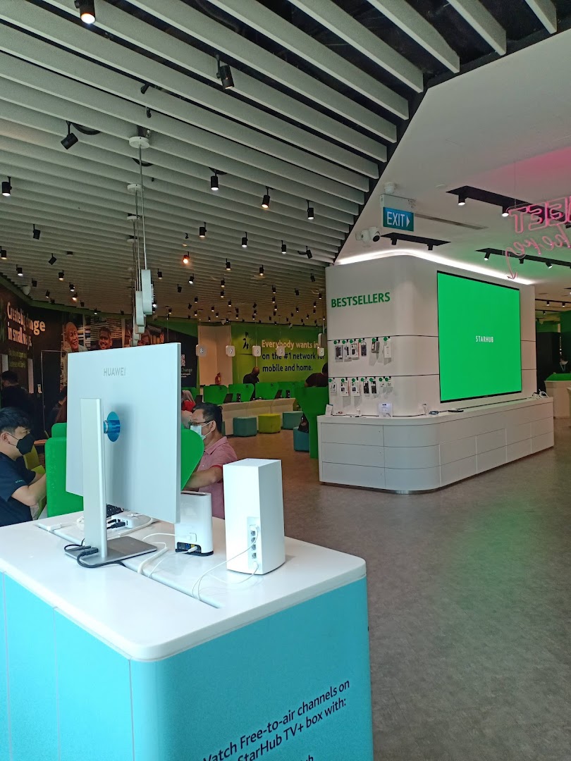 Interior view of StarHub Tampines Mall, showcasing modern displays, customer service areas, and technology products.