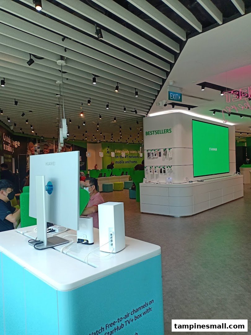 Interior view of StarHub Tampines Mall, showcasing modern displays, customer service areas, and technology products.