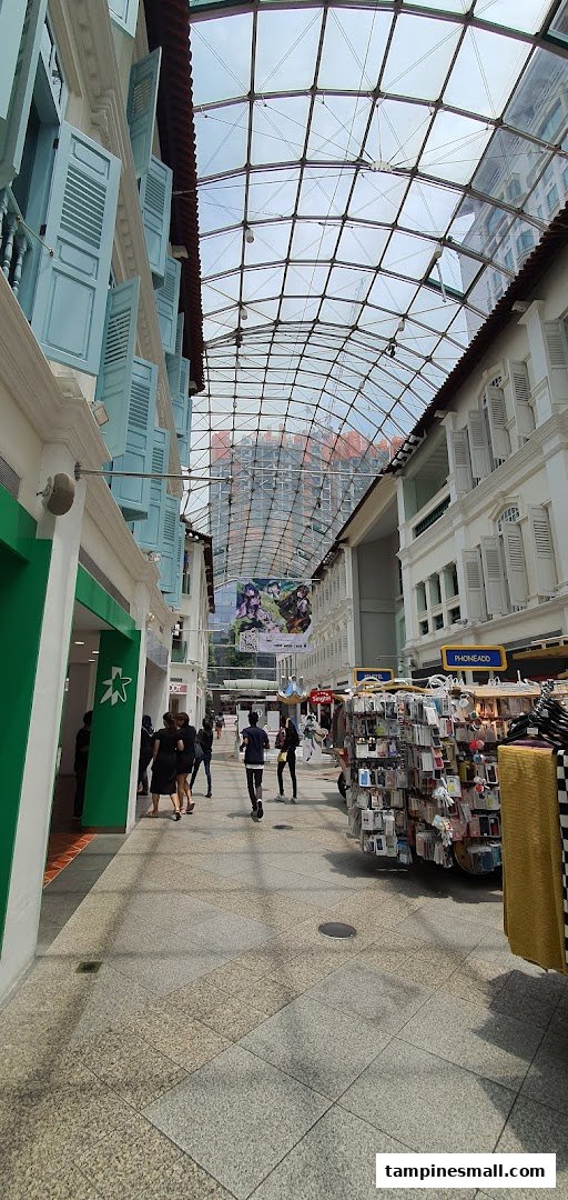 A view of the StarHub shop entrance within a bustling covered pedestrian walkway with traditional architecture.