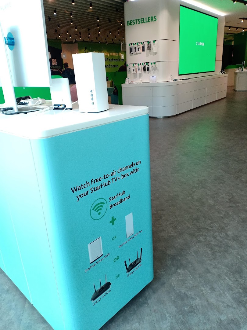 Interior view of StarHub store showcasing broadband services, routers, and a large display screen.