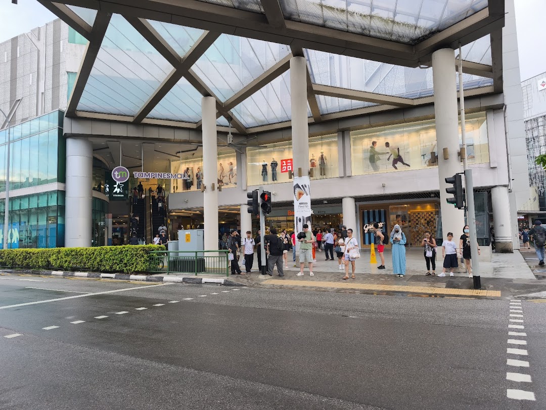 Exterior view of Tampines Mall entrance, showcasing the main facade, pedestrian area, and StarHub branding.