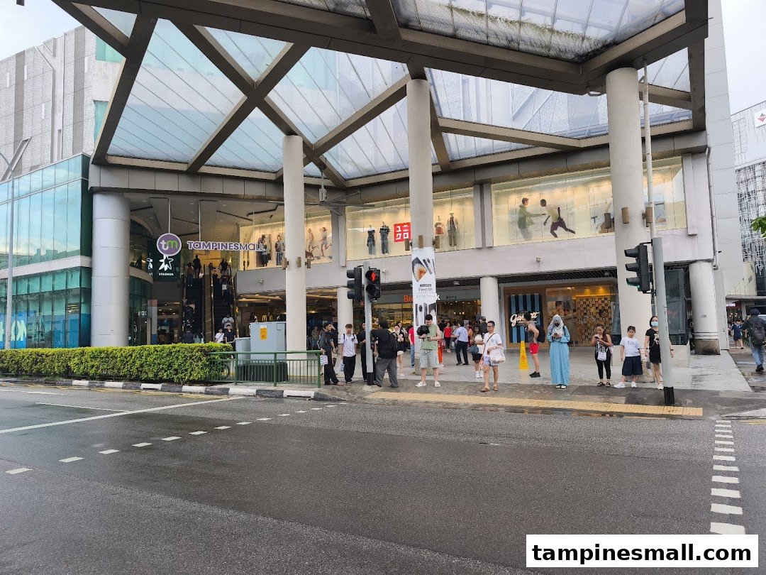 Exterior view of Tampines Mall entrance, showcasing the main facade, pedestrian area, and StarHub branding.