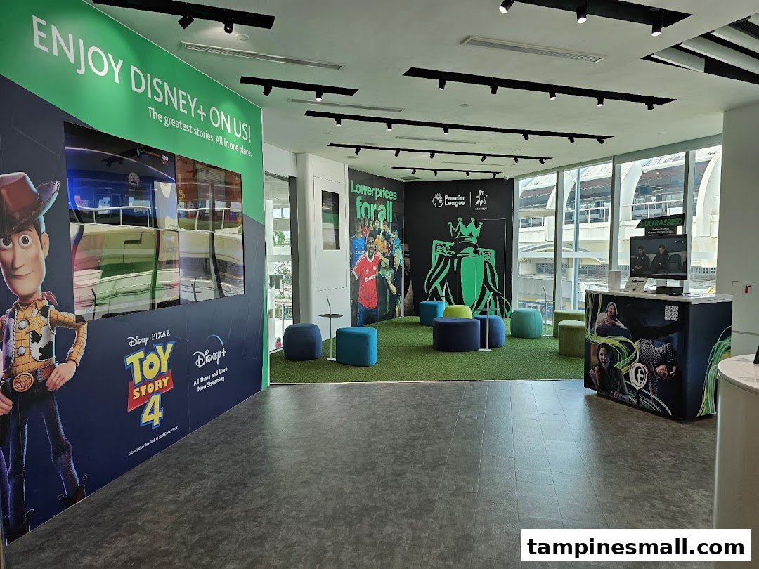 Modern StarHub interior featuring Disney+ and Premier League displays, with a comfortable seating area.