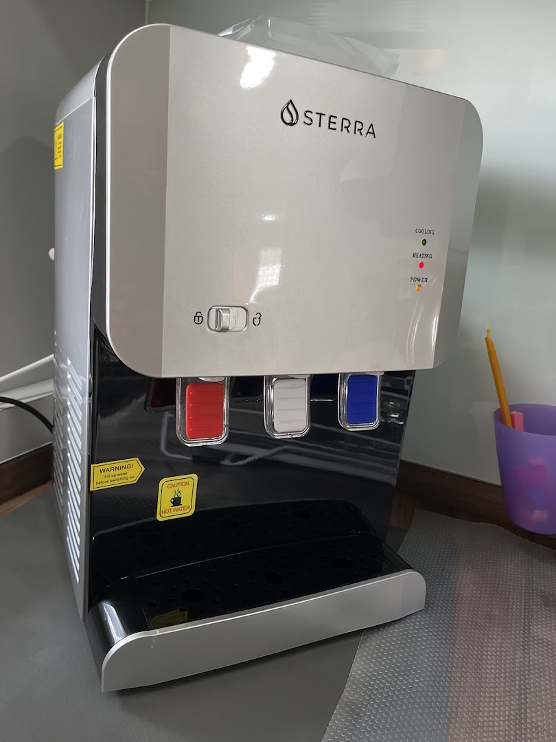 A sleek Sterra water dispenser with hot, cold, and ambient water options.