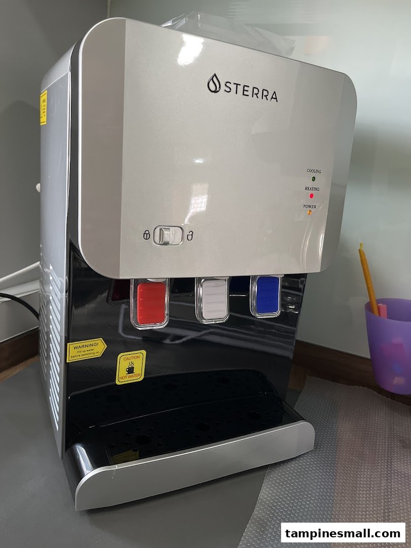 A sleek Sterra water dispenser with hot, cold, and ambient water options.
