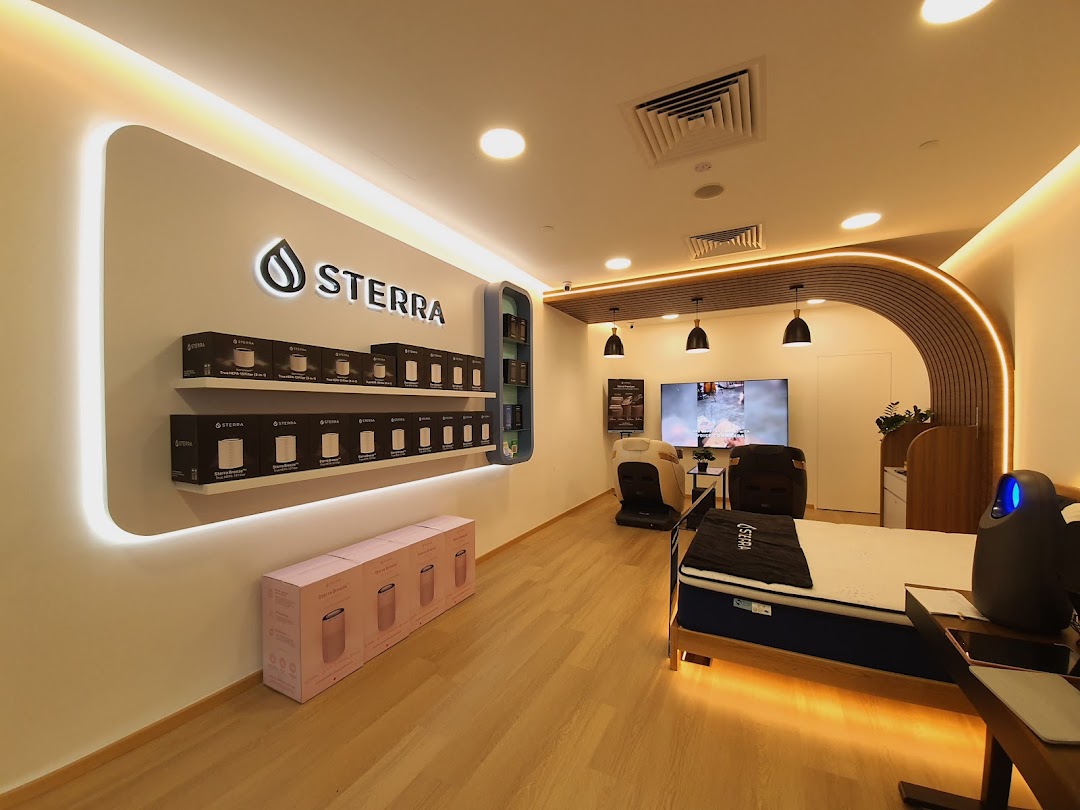 Interior view of Sterra Singapore, showcasing air purifiers, a mattress, and massage chairs.