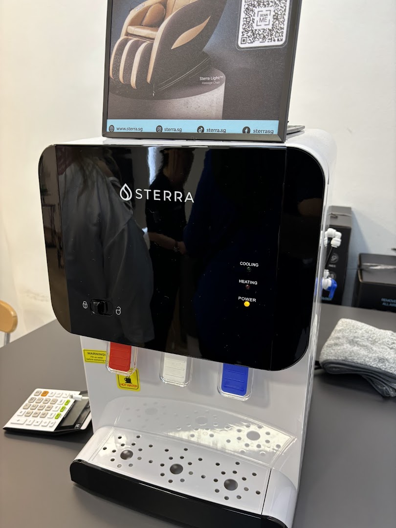 A Sterra water dispenser and a display for a Sterra Light Massage Chair in the shop.