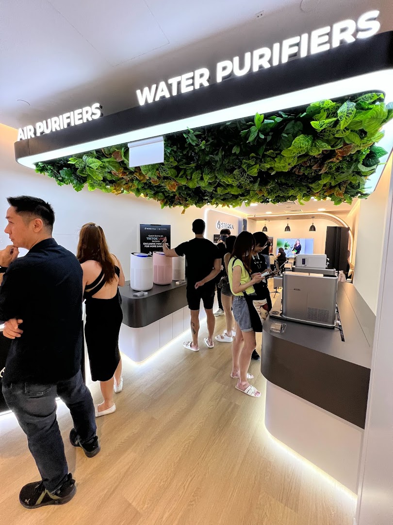 Customers browse air and water purifiers in a modern Sterra Singapore store.