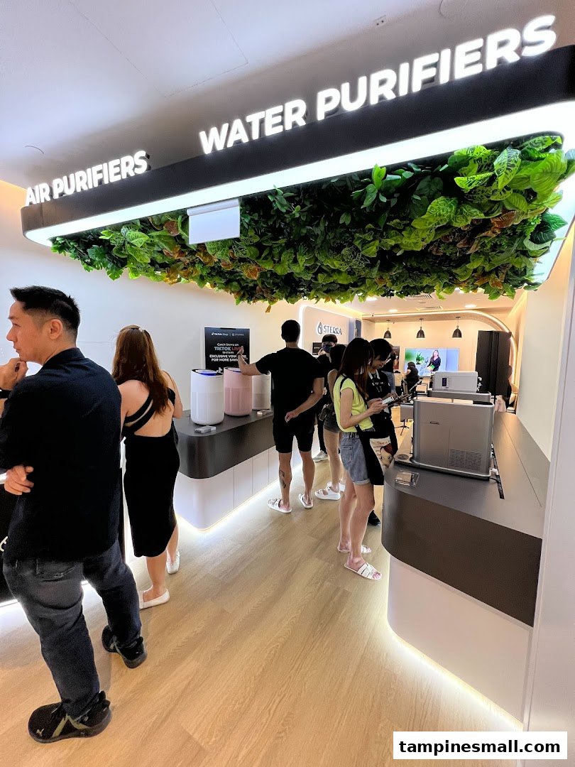 Customers browse air and water purifiers in a modern Sterra Singapore store.