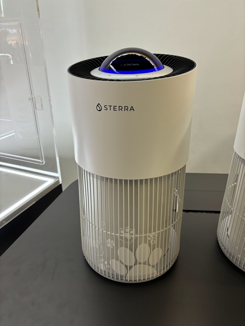 A white Sterra air purifier with pet paw print design on display.