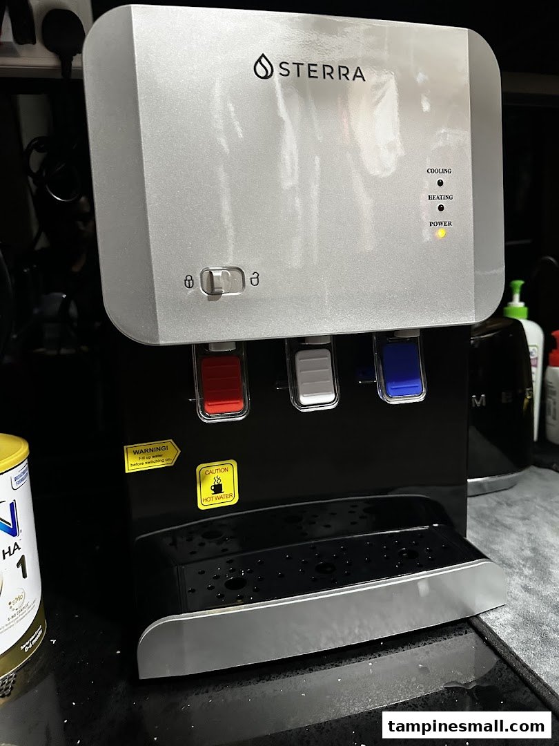 A close-up of a Sterra water dispenser with hot and cold water options.