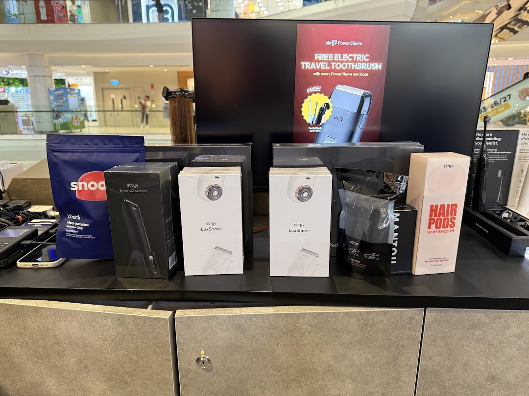 A display of Stryv personal grooming products, including shavers, hair pods, and a promotional offer.