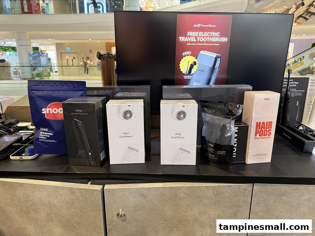 A display of Stryv personal grooming products, including shavers, hair pods, and a promotional offer.