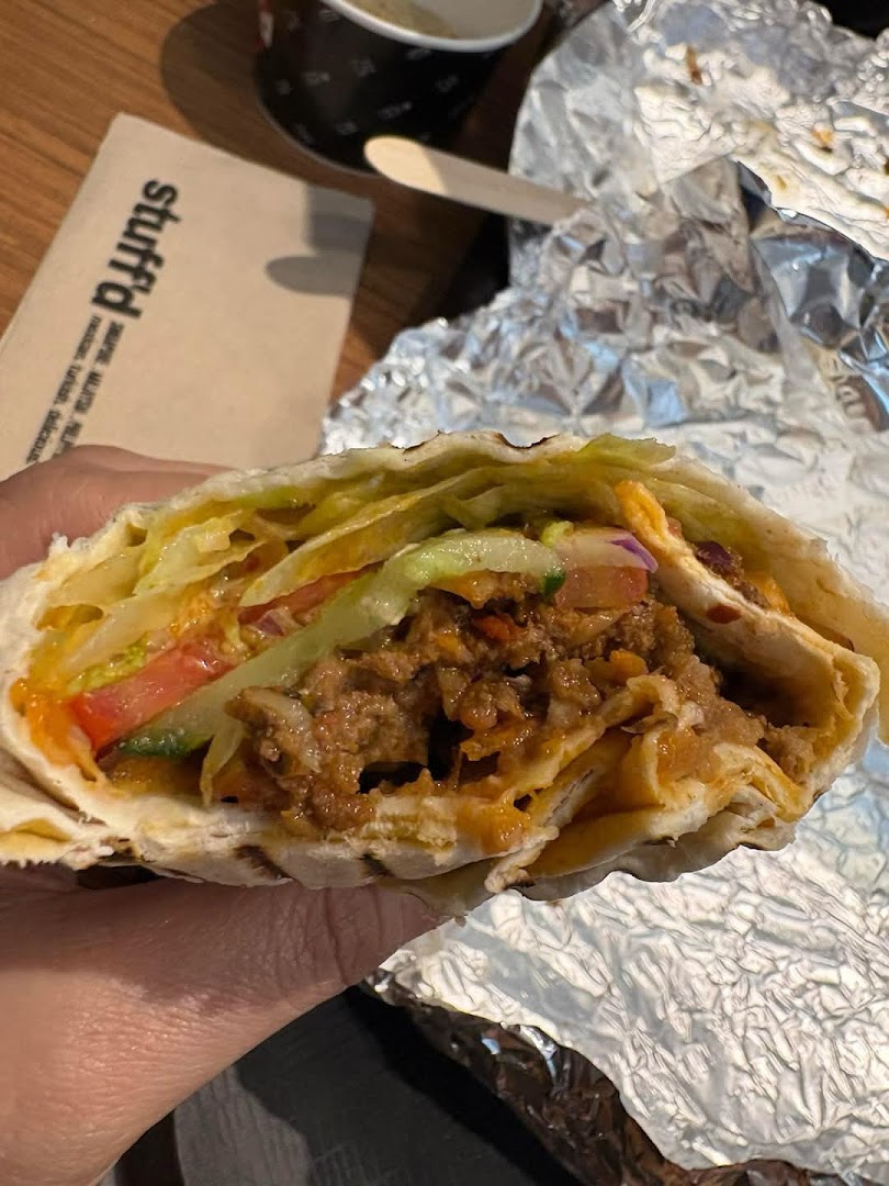 A close-up of a delicious, generously filled wrap from Stuffd, showcasing its fresh ingredients.