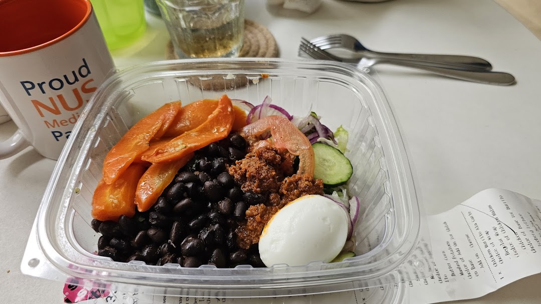A vibrant, customizable salad bowl from Stuffd featuring fresh ingredients and a hard-boiled egg.