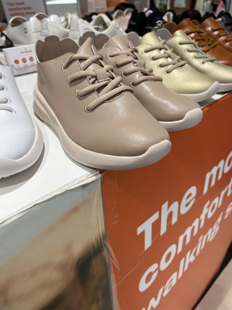 Close-up of Sunnystep comfortable walking shoes in various colors displayed in the store.