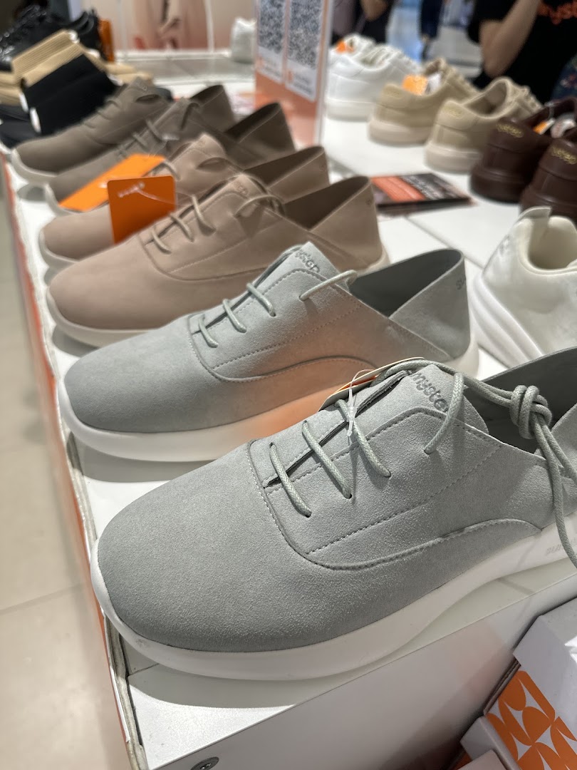 A close-up view of various comfortable and stylish shoes displayed on shelves at Sunnystep.