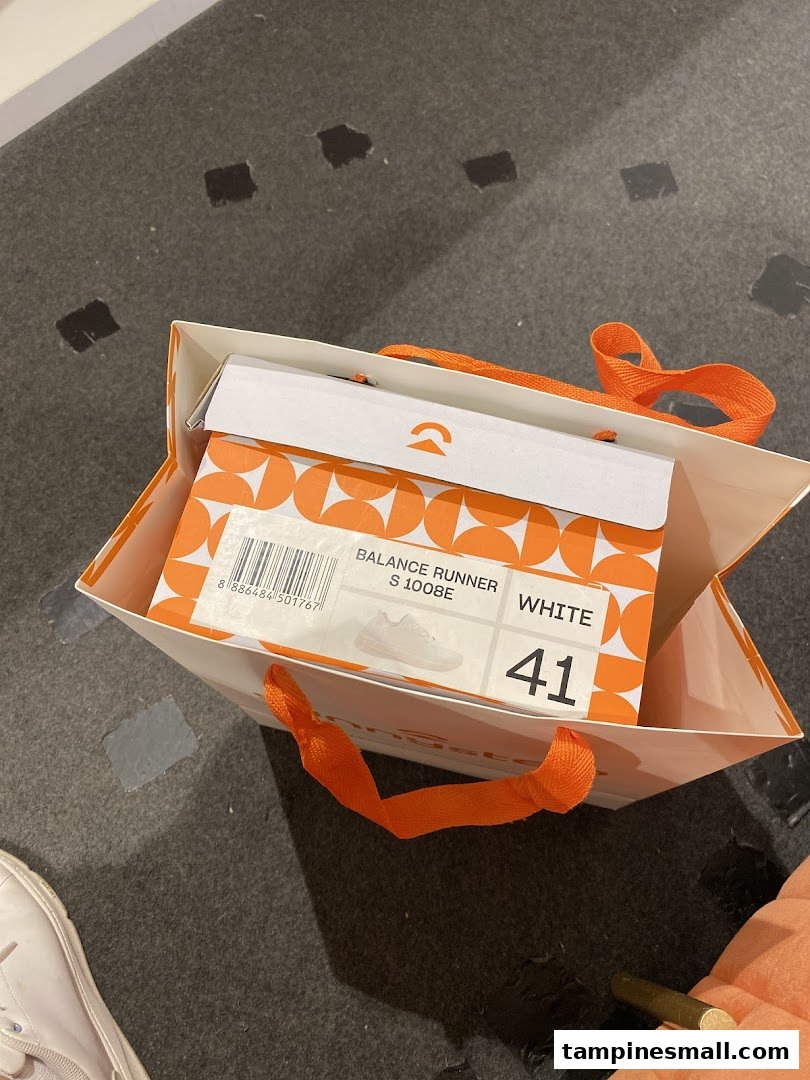 A Sunnystep shopping bag containing a shoebox for 'Balance Runner' shoes in white, size 41.